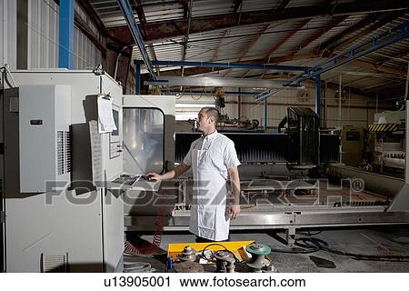 Industrial factory worker operating machinery View Large Photo Image Stock Image - Industrial factory worker operating machinery. Fotosearch