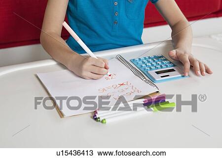 Midsection of a girl writing in book doing homework View Large Photo Image Stock Image - Midsection of a girl writing in book doing homework. Fotosearch