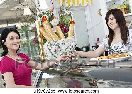 Portrait of a beautiful female customer taking espresso coffee from young caterer in cafe View Large Photo Image Stock Photography - Portrait of a beautiful female customer taking espresso coffee from young caterer in cafe. Fotosearch