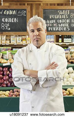 Portrait of a confident chef with arms crossed in market View Large Photo Image Stock Photo - Portrait of a confident chef with arms crossed in market. Fotosearch