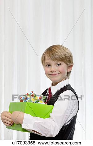 Portrait of a happy boy with gift View Large Photo Image Stock Photo - Portrait of a happy boy with gift. Fotosearch