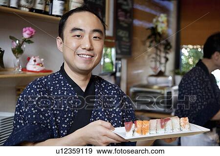 Portrait of a happy chef with sushi in restaurant View Large Photo Image Stock Photo - Portrait of a happy chef with sushi in restaurant. Fotosearch