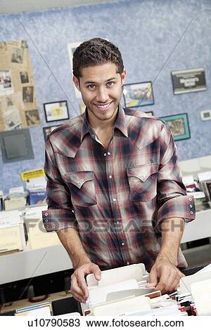 Portrait of a happy customer searching record album in music store View Large Photo Image Stock Image - Portrait of a happy customer searching record album in music store. Fotosearch