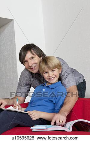 Portrait of a happy father helping son doing homework View Large Photo Image Stock Photo - Portrait of a happy father helping son doing homework. Fotosearch