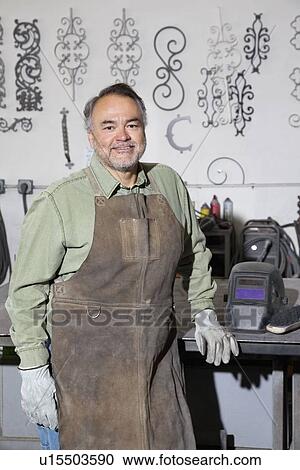 Portrait of a happy mature metalworker in workshop View Large Photo Image Stock Image - Portrait of a happy mature metalworker in workshop. Fotosearch