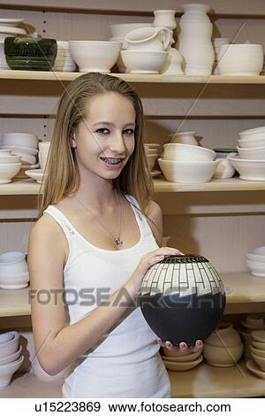 Portrait of a happy teenage girl with vase in workshop View Large Photo Image Stock Photo - Portrait of a happy teenage girl with vase in workshop. Fotosearch
