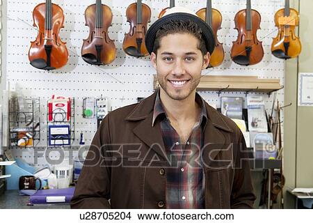 Portrait of a happy young music store owner View Large Photo Image Picture - Portrait of a happy young music store owner. Fotosearch