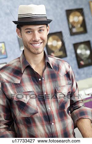 Portrait of a happy young music store owner View Large Photo Image Stock Photo - Portrait of a happy young music store owner. Fotosearch