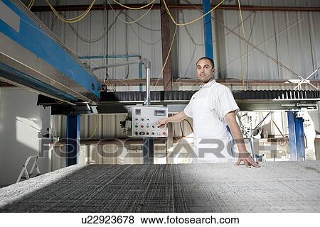 Stock Photo - Portrait of a industrial worker operating machinery. Fotosearch