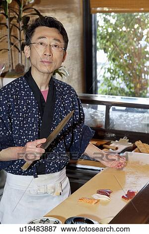 Portrait of a mature chef preparing sushi View Large Photo Image Stock Photo - Portrait of a mature chef preparing sushi. Fotosearch