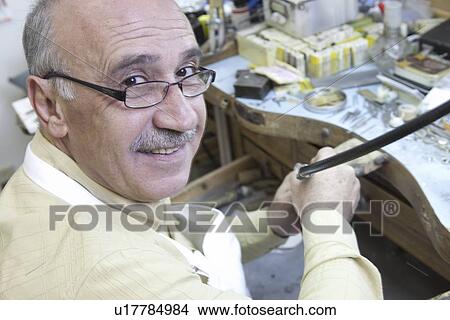 Portrait of a mature skilled worker in repair workshop View Large Photo Image Picture - Portrait of a mature skilled worker in repair workshop. Fotosearch