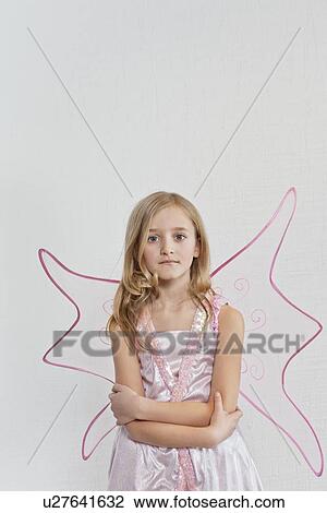 Portrait of a young girl with arms crossed over colored background View Large Photo Image Stock Image - Portrait of a young girl with arms crossed over colored background. Fotosearch