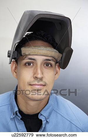 Portrait of a young metalworker over colored background View Large Photo Image Stock Photo - Portrait of a young metalworker over colored background. Fotosearch