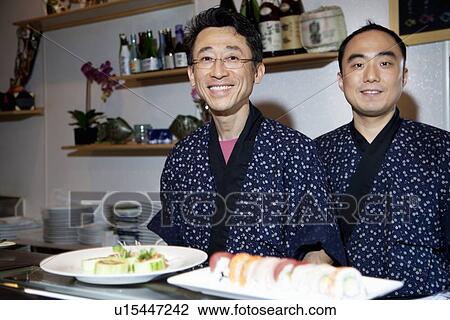 Portrait of happy Asian chefs with sushi in foreground View Large Photo Image Stock Image - Portrait of happy Asian chefs with sushi in foreground. Fotosearch