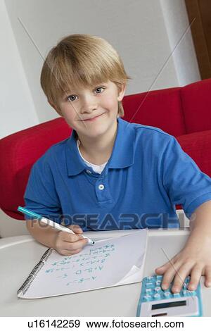 Portrait of little boy doing homework View Large Photo Image Stock Photo - Portrait of little boy doing homework. Fotosearch