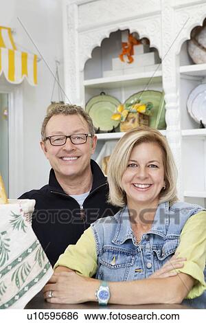 Portrait of mature couple in cake shop View Large Photo Image Stock Photograph - Portrait of mature couple in cake shop. Fotosearch