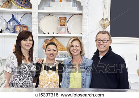 Portrait of mature couple with employees in cake shop View Large Photo Image Stock Photograph - Portrait of mature couple with employees in cake shop. Fotosearch