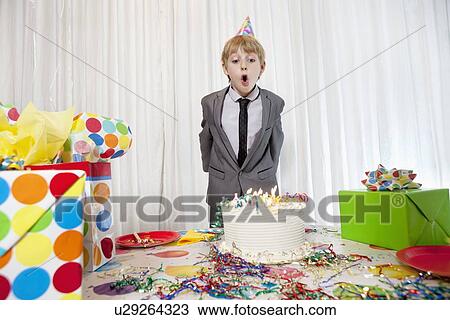 Pre-teen birthday boy blowing candles on cake View Large Photo Image Stock Image - Pre-teen birthday boy blowing candles on cake. Fotosearch