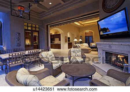 Seating furniture near fireplace with television in room of luxury villa View Large Photo Image Stock Image - Seating furniture near fireplace with television in room of luxury villa. Fotosearch