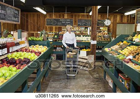 Senior woman shopping in grocery store View Large Photo Image Stock Photography - Senior woman shopping in grocery store. Fotosearch