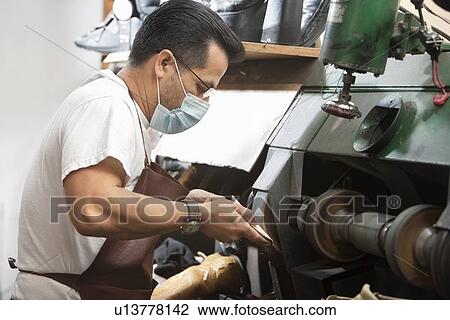 Side view of skilled cobbler rubbing shoe sole in machinery View Large Photo Image Stock Image - Side view of skilled cobbler rubbing shoe sole in machinery. Fotosearch