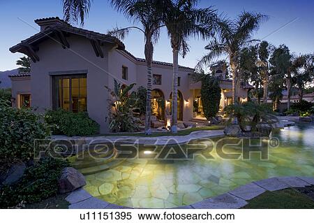 Swimming pool in foreground of luxury mansion View Large Photo Image Stock Photography - Swimming pool in foreground of luxury mansion. Fotosearch