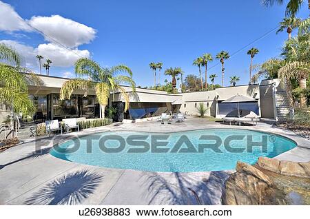 Stock Image - Swimming pool in front of mansion. Fotosearch