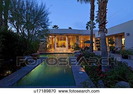 Swimming pool outside mansion at dusk View Large Photo Image Stock Image - Swimming pool outside mansion at dusk. Fotosearch