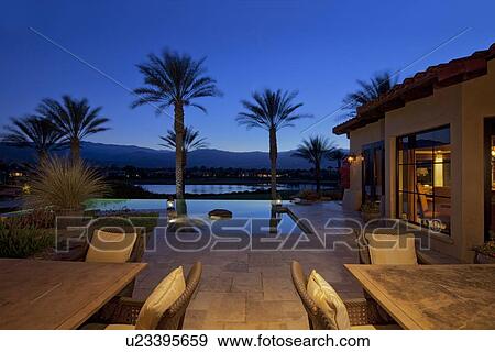 Table and chair in poolside patio of luxury villa View Large Photo Image Stock Photo - Table and chair in poolside patio of luxury villa. Fotosearch