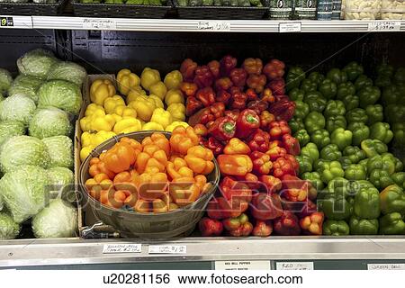 Variety of bell peppers on display for sale in market View Large Photo Image Stock Photograph - Variety of bell peppers on display for sale in market. Fotosearch