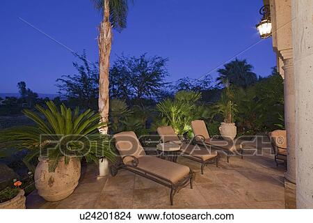 Picture - View of chaise lounge in patio of luxury manor house. Fotosearch