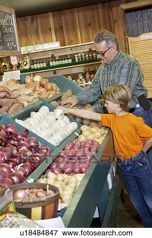 Young boy with grandfather selecting white onions at vegetable stand in produce market View Large Photo Image Stock Photo - Young boy with grandfather selecting white onions at vegetable stand in produce market. Fotosearch