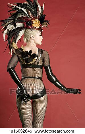 Back view of woman in fishnet stockings and leather standing over colored background View Large Photo Image Stock Photography - Back view of woman in fishnet stockings and leather standing over colored background. Fotosearch