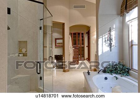 Stock Image - Bathtub with glass door in bathroom of luxury manor house. Fotosearch
