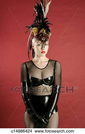 Beautiful pinup woman wearing fishnet stockings standing over colored background View Large Photo Image Picture - Beautiful pinup woman wearing fishnet stockings standing over colored background. Fotosearch