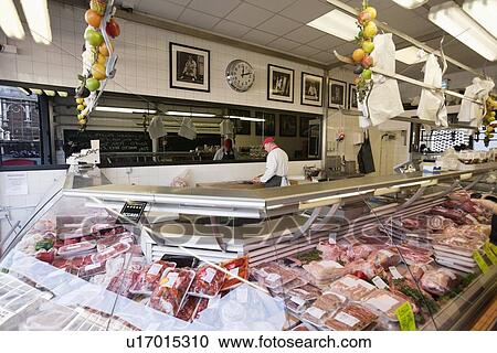 Butcher working in behind with huge amount of meat displayed in case View Large Photo Image Stock Image - Butcher working in behind with huge amount of meat displayed in case. Fotosearch