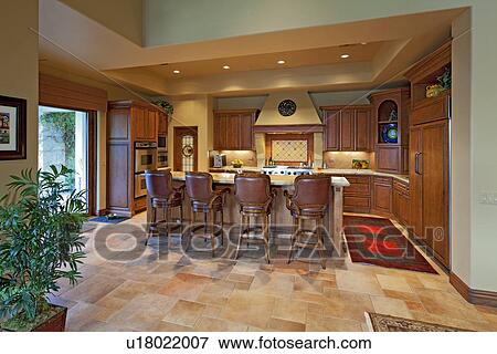 Stock Photo - Chairs near contemporary kitchen counter in luxury manor house. Fotosearch