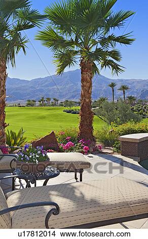 Picture - Chaise lounges with mountain in background. Fotosearch