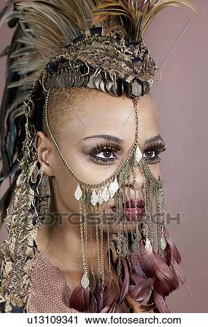 Close-up of an African American woman wearing headgear and jewelry View Large Photo Image Stock Image - Close-up of an African American woman wearing headgear and jewelry. Fotosearch