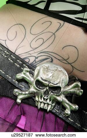 Stock Photo - Close-up of skull and crossbones on belt of punk woman. Fotosearch