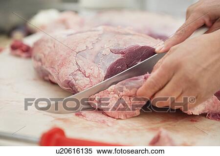 Close-up view of hands slicing meat in butcher shop View Large Photo Image Stock Photography - Close-up view of hands slicing meat in butcher shop. Fotosearch