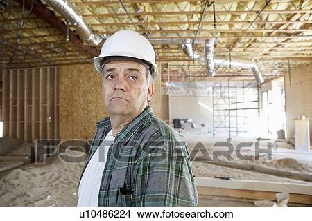 Contractor wearing hardhat looking away View Large Photo Image Picture - Contractor wearing hardhat looking away. Fotosearch