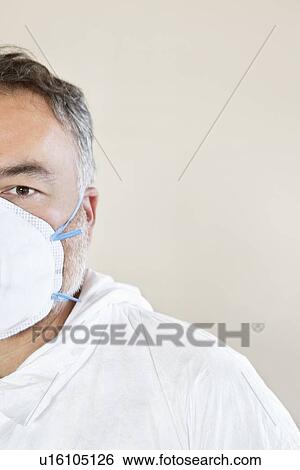 Cropped image of a male worker wearing a protective mask View Large Photo Image Stock Photograph - Cropped image of a male worker wearing a protective mask. Fotosearch