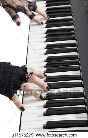 Cropped image of female fingers playing piano keyboard View Large Photo Image Stock Photo - Cropped image of female fingers playing piano keyboard. Fotosearch
