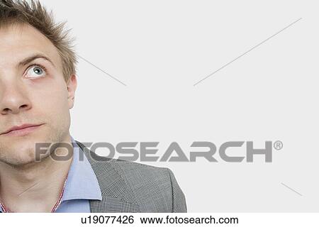 Cropped image of young businessman over light gray background View Large Photo Image Stock Photograph - Cropped image of young businessman over light gray background. Fotosearch