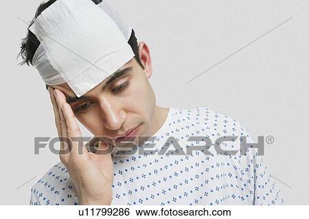 Stock Photograph - Depressed patient with hand on head. Fotosearch