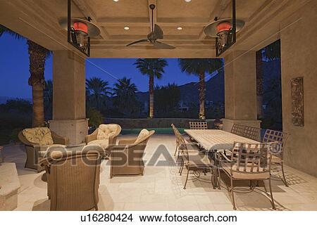 Dining table and chair in patio of mansion View Large Photo Image Picture - Dining table and chair in patio of mansion. Fotosearch