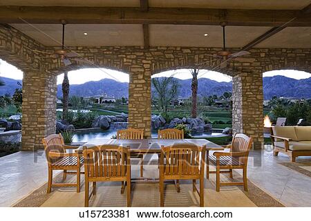 Stock Image - Dining table and chair in patio of luxury villa. Fotosearch