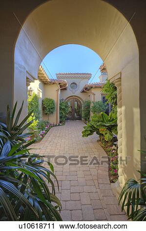 Stock Image - Doorway to courtyard of luxury manor house. Fotosearch
