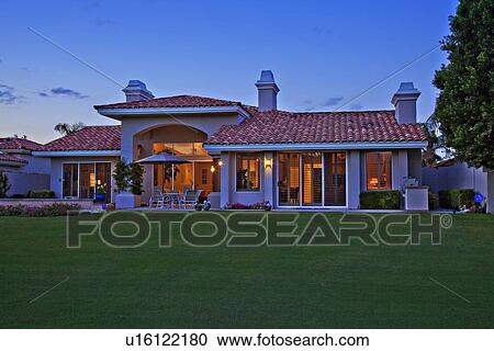 Stock Image - Facade of luxurious villa with lawn in foreground. Fotosearch